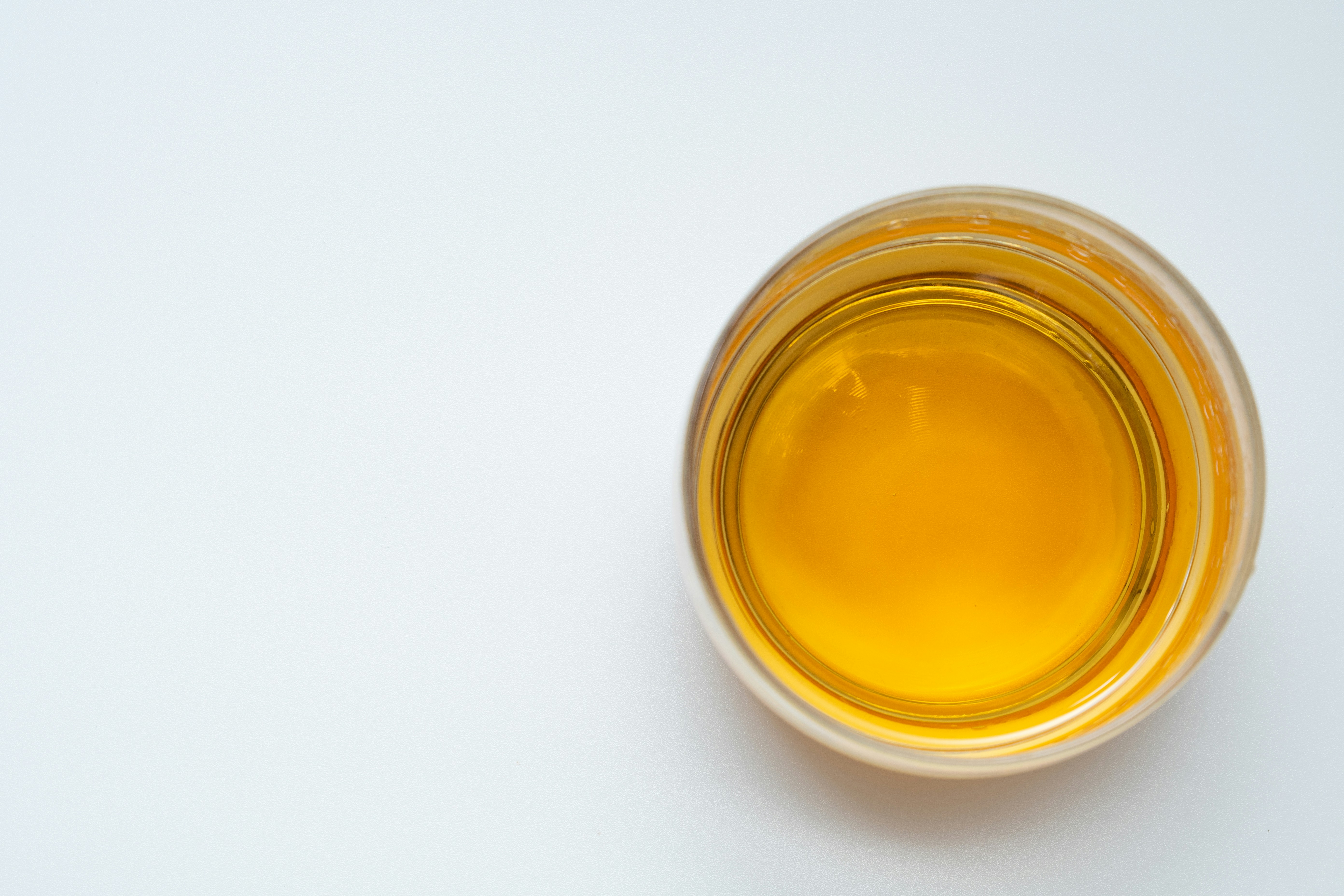 cup of oil on white background